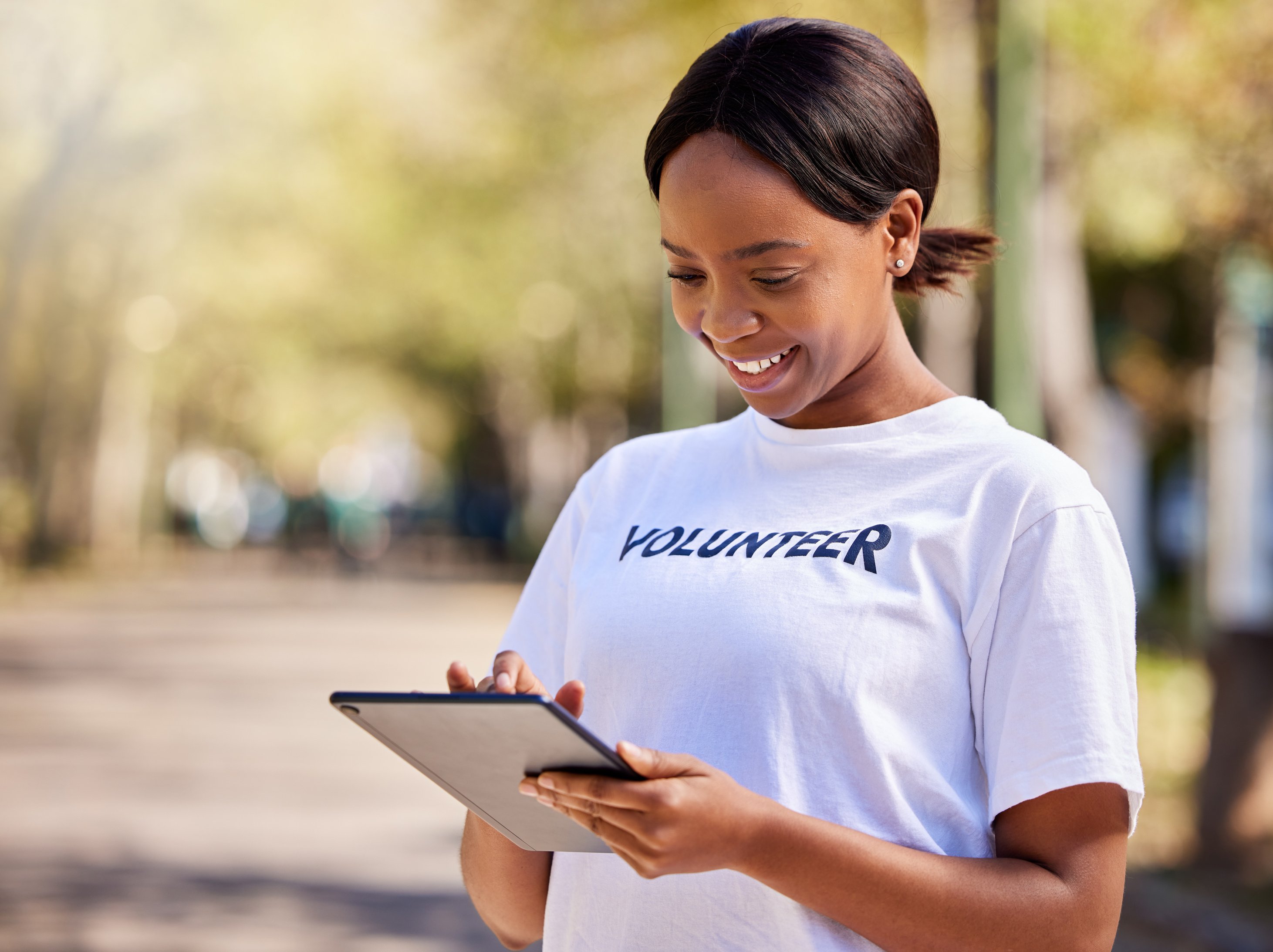 Woman, Tablet and Volunteering in Park on Social Media FAQ, Blog or Community Service Website. African Person on Digital Technology for Earth Day Information, NGO or Nonprofit Sign up in Nature